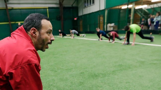 In this Wednesday, Feb. 27, 2019, photo, Anthony Sarigianopoulos trains children and young adults at the Sluggers of Ohio gym, in Youngstown, Ohio. Sarigianopoulos, who checks and fixes cars at the end of the line, knows he is fortunate to have a shot at a job even if it's somewhere else, unlike most of the 8,000 white-collar employees GM is laying off and those who are losing jobs at the automaker's nearby parts suppliers. (AP Photo/Tony Dejak)