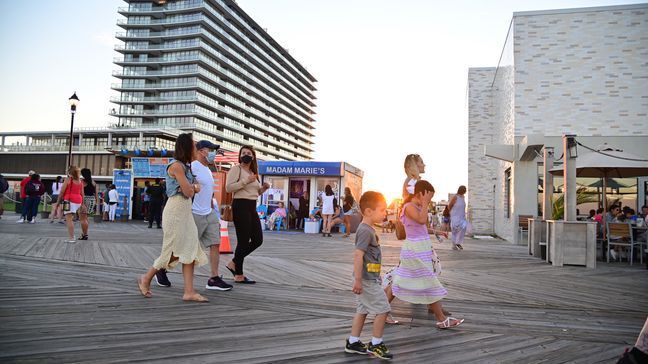 People walk along the Asbury Park boardwalk on September 05, 2020 in Asbury Park, NJ, United States. The fourth phase allows outdoor arts and entertainment, sporting events without fans and media production. (Photo by Theo Wargo/Getty Images)