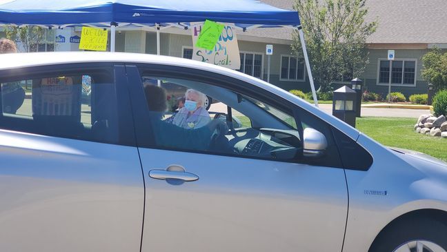 Cars drive by to wish Sister Cecile a happy birthday. (WWMT/ Manny Revilla)