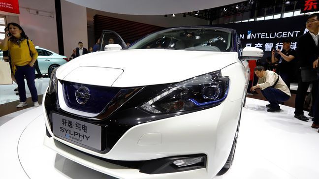 Visitors examine the newly unveiled Sylphy Zero Emission during the start of the Auto China 2018 in Beijing, China, Wednesday, April 25, 2018. Volkswagen and Nissan have unveiled electric cars designed for China at the Beijing auto show that highlights the growing importance of Chinese buyers for a technology seen as a key part of the global industry's future. (AP Photo/Ng Han Guan)