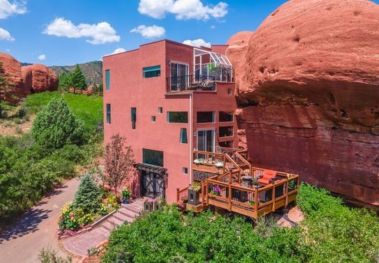 Image for story: GALLERY: Flintstones-style 'Rock House' built around 200 million year old cliff