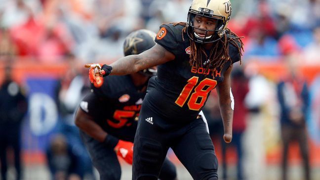 FILE - In this Jan. 27, 2018, file photo, South Squad outside linebacker Shaquem Griffin, of Central Florida, gestures during the first half of the Senior Bowl NCAA college football game in Mobile, Ala,. Griffin was 4 years old when doctors amputated his left hand a day after his mother found him in the kitchen attempting to cut off his jelly-like fingers, which were in scoring pain whenever he touched anything, the result of amniotic band syndrome, a congenital birth defect.  (AP Photo/Brynn Anderson, File)