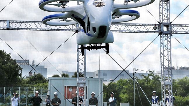 NEC Corp.'s machine with propellers hovers at the company's facility in Abiko near Tokyo, Monday, Aug. 5, 2019. The Japanese electronics maker showed a "flying car," a large drone-like machine with four propellers that hovered steadily for about a minute. (AP Photo/Koji Sasahara)