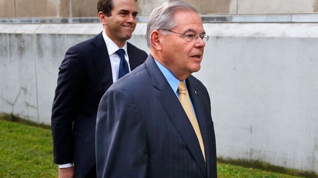 FILE - Sen. Bob Menendez, right, walks with his son Robert Menendez Jr., in Newark, N.J., Sept. 6, 2017. (AP Photo/Seth Wenig, File)