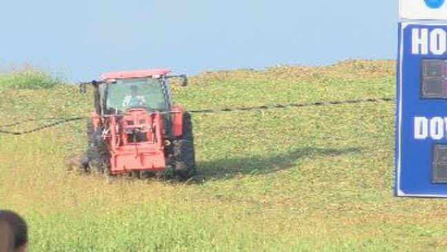 Alex Couch mowing before Castlewood's home opener (WCYB photo)