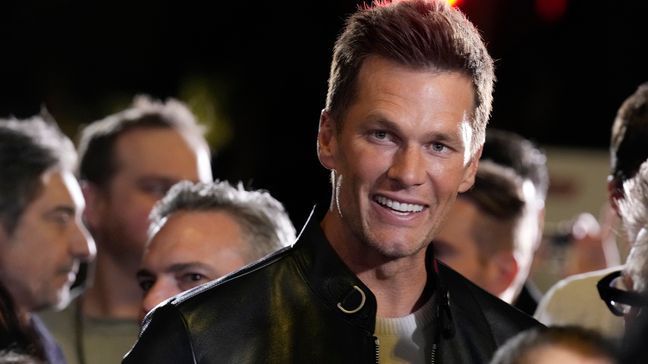 NFL quarterback Tom Brady, a cast member and producer of "80 for Brady," looks down the carpet at the premiere of the film, Tuesday, Jan. 31, 2023, at the Regency Village Theatre in Los Angeles. (AP Photo/Chris Pizzello)