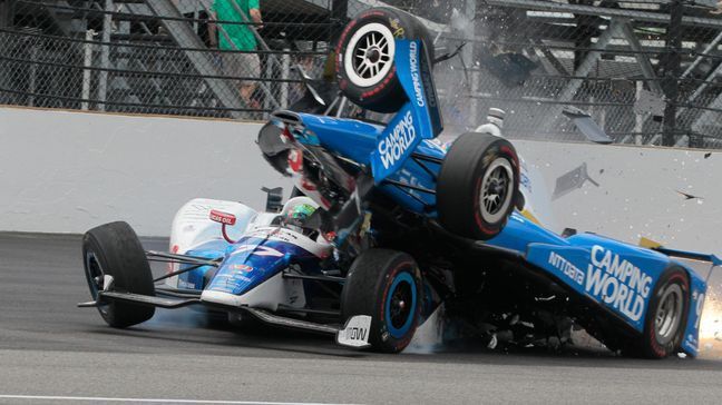 Scott Dixon, of New Zealand, begins to go over the top of Jay Howard, of England, during the running of the Indianapolis 500 auto race at Indianapolis Motor Speedway, Sunday, May 28, 2017, in Indianapolis. (AP Photo/Bill Friel)