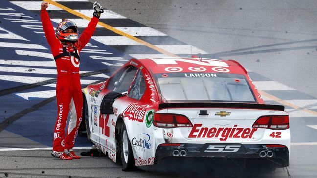 Kyle Larson celebrates winning a NASCAR Cup Series auto race in Brooklyn, Mich., Sunday, Aug. 13, 2017. (AP Photo/Paul Sancya)