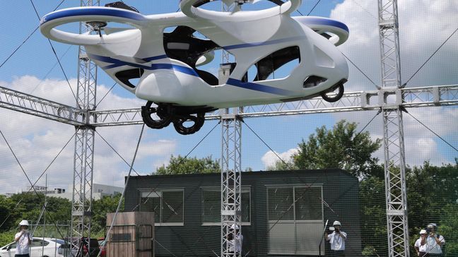 NEC Corp.'s machine with propellers hovers at the company's facility in Abiko near Tokyo, Monday, Aug. 5, 2019. The Japanese electronics maker showed a "flying car," a large drone-like machine with four propellers that hovered steadily for about a minute. (AP Photo/Koji Sasahara)