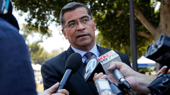 California Attorney General Xavier Becerra talks to reporters after a news conference at University of California, Los Angeles Thursday, Aug. 2, 2018. Becerra spoke about his efforts to fight the Trump administration's proposal to weaken car efficiency fuel standards. (AP Photo/Jae C. Hong)