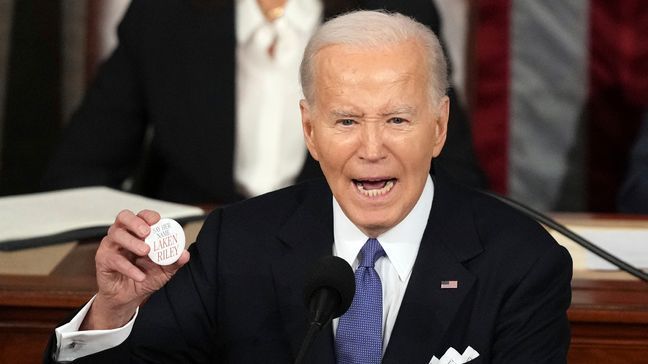 President Joe Biden holds up a Laken Riley Botton as he delivers the State of the Union address to a joint session of Congress at the U.S. Capitol, Thursday March 7, 2024, in Washington. (AP Photo/Andrew Harnik)