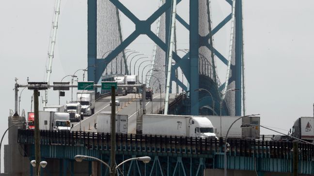 In this Tuesday, June 12, 2018, photo, trucks cross the Ambassador Bridge from Windsor, Ontario into Detroit. In nearly a quarter-century since NAFTA was approved, a complex chain of automotive parts makers has sprung up on both sides of the U.S.-Canada border. About 7,400 trucks cross the bridge between Detroit and Windsor every day, many laden with auto parts. (AP Photo/Paul Sancya)