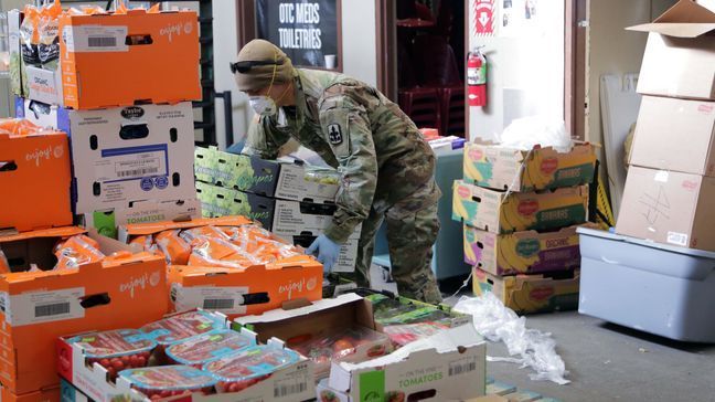 Alaska Army National Guard Soldier Sgt. Kekoa Maclovesramirez stacks boxes of food donated from local Alaskan food banks at Beans Cafe in Anchorage, Alaska, Apr. 8, 2020. Amid the COVID-19 pandemic, Alaska National Guard Soldiers have taken the weight of the load for much needed volunteer hours at Beans Cafe, that feeds thousands of local Alaskans in the Anchorage area. (U.S Army National Guard photo by Sgt. Seth LaCount/Released)