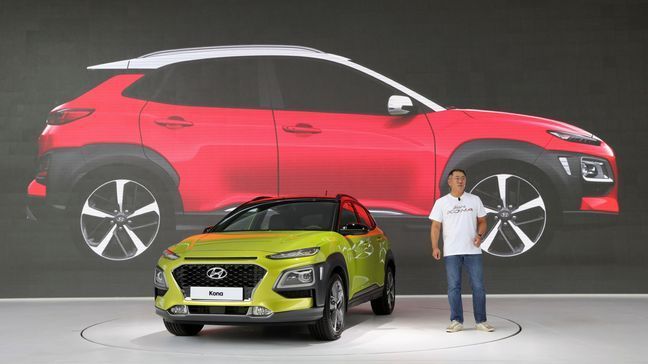 Euisun Chung, a vice chairman of Hyundai Motor, speaks next to new SUV Kona during its world premiere in Goyang, South Korea, Tuesday, June 13, 2017. Hyundai Motor Co. is playing catch up in the fast-growing sport utility vehicle market with its first subcompact SUV targeting Europe and North America. (AP Photo/Lee Jin-man)