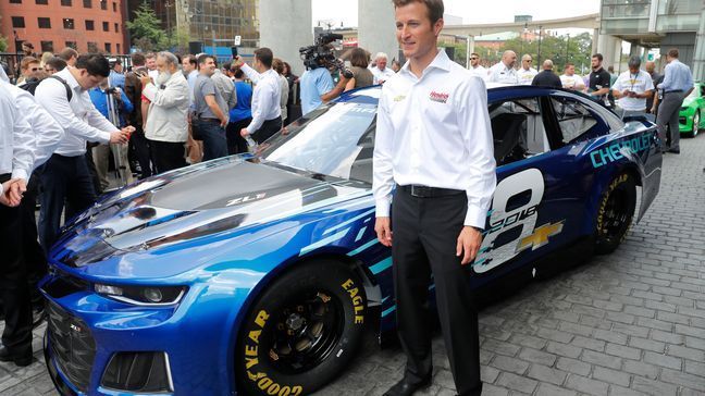 Kasey Kahne poses with the 2018 Chevrolet Camaro ZL1 as the new race car was introduced for the Monster Energy NASCAR Cup Series during a news conference in Detroit, Thursday, Aug. 10, 2017. The new Camaro will make its on-track debut during the 2018 Daytona 500. (AP Photo/Paul Sancya)