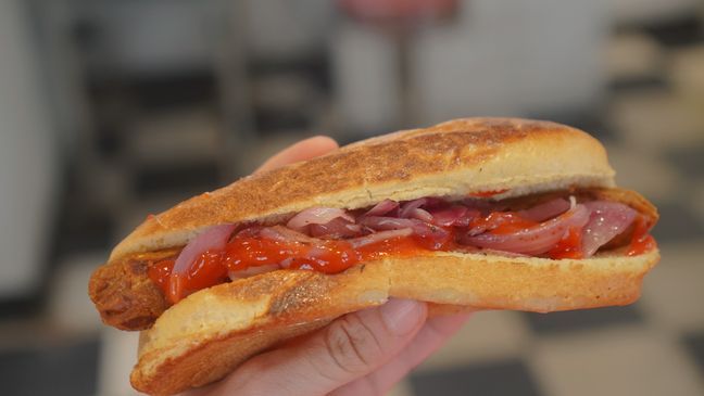 Ketchup and onions add classic flavors to the vegan hot dog at Sporty Dog in Baltimore, but adventurous eaters can try theirs topped with unconventional options like strawberries. (Photo: Emily Faber, The National Desk)