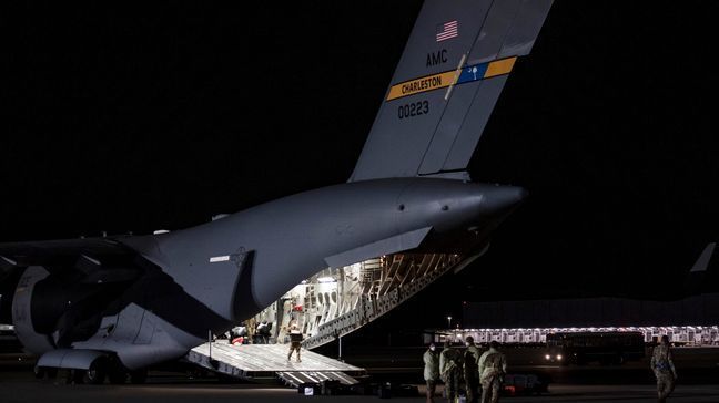 Airmen unload medical equipment after transporting COVID-19 patients during the first-ever operational use of the Transport Isolation System at Ramstein Air Base, Germany on April 10, 2020. (Photo:{&nbsp;}Air Force Staff Sgt. Devin Nothstine)