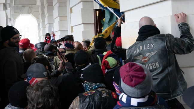 FILE - Insurrectionists loyal to President Donald Trump try to open a door of the U.S. Capitol as they riot in Washington, Jan. 6, 2021. (AP Photo/Jose Luis Magana, File)