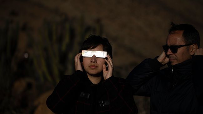 FILE - People watch a total solar eclipse in La Higuera, Chile, Tuesday, July 2, 2019. Small towns and rural enclaves along the path of Aprilâs 2024 total solar eclipse are steeling for huge crowds of sun chasers who plan to catch a glimpse of day turning into dusk in North America.  (AP Photo/Esteban Felix, File)