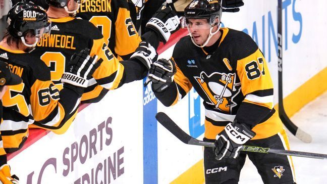 Pittsburgh Penguins' Sidney Crosby (87) returns to the bench after scoring during the first period of an NHL hockey game against the Philadelphia Flyers in Pittsburgh, Sunday, Feb. 25, 2024. (AP Photo/Gene J. Puskar)