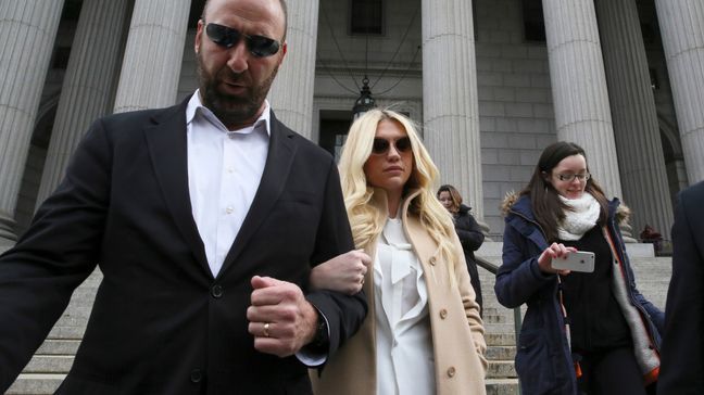 Pop star Kesha, center, leaves Supreme court in New York, Friday, Feb. 19, 2016. Kesha is fighting to wrest her career away from a hitmaker she says drugged, sexually abused and psychologically tormented her _ and still has exclusive rights to make records with her. Producer Dr. Luke says the singer is slinging falsehoods and ruining his reputation to try to weasel out of her recording contract and strike a new deal.  (AP Photo/Mary Altaffer)