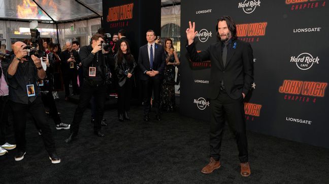 Keanu Reeves, right, star of "John Wick: Chapter 4," arrives at the premiere of the film, Monday, March 20, 2023, at the TCL Chinese Theatre in Los Angeles. (AP Photo/Chris Pizzello)