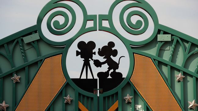 FILE - In this Sunday, June 8, 2018 file photo, a Mickey Mouse sign is displayed on the gate of the first Avengers-themed entrance at Disneyland Paris, in Chessy, France, east of Paris. (AP Photo/Francois Mori, File)