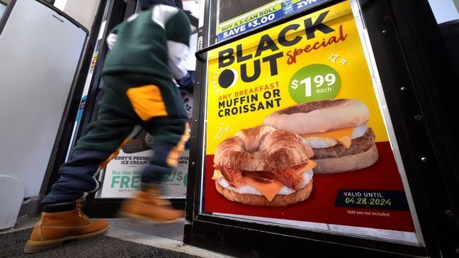 A sign on the door of a Country Fair mini-mart in downtown Erie, Pa., promotes a breakfast sandwich special to coincide with the upcoming total solar eclipse that Erie, Pa., will experience, with a little luck from the weather, on April 8. (AP Photo/Gene J. Puskar)