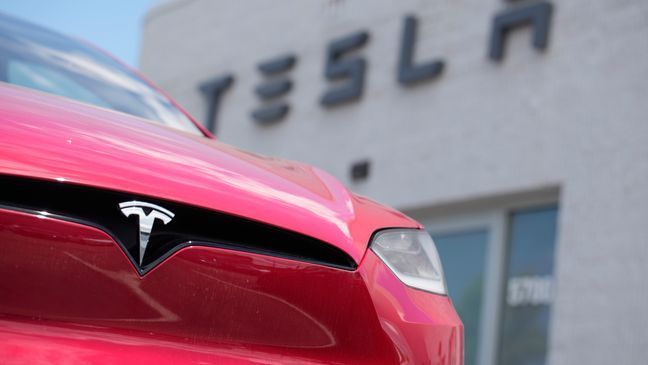 FILE - A Model X sports-utility vehicle sits outside a Tesla store in Littleton, Colo., June 18, 2023. (AP Photo/David Zalubowski, File)