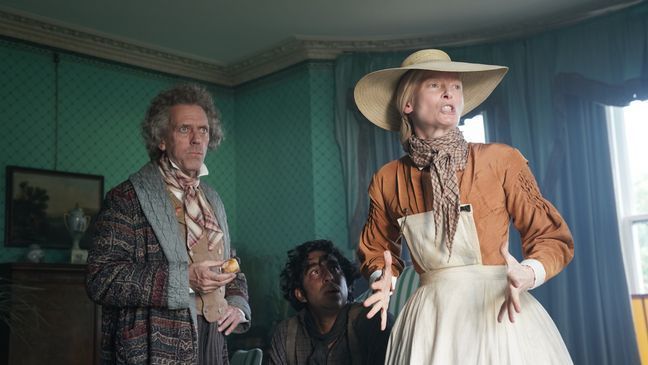 (From L-R): Hugh Laurie, Dev Patel and Tilda Swinton in the film THE PERSONAL HISTORY OF DAVID COPPERFIELD. Photo by Dean Rogers. © 2020 20th Century Studios All Rights Reserved