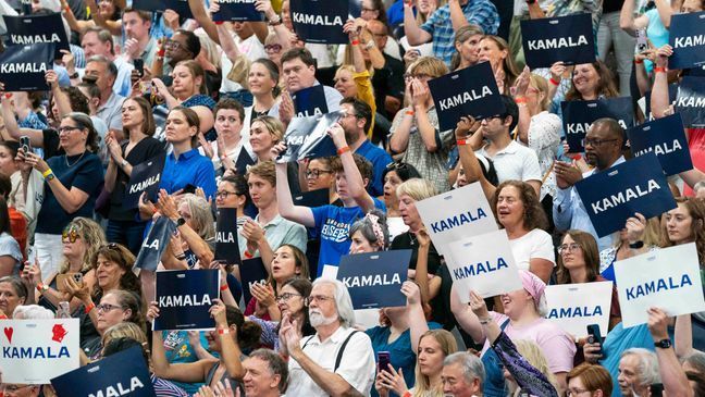 FILE - Supports hold up signs in support of Vice President Kamala Harris at an event, July 23, 2024, in West Allis, Wis. Voters, especially those who lean left, are expressing a renewed interest in the campaign and eager to see Harris take on the Democratic Party mantle in place of President Joe Biden. Harrisâ campaign is trying to capitalize on a jolt of fundraising, volunteer interest and media attention after Democrats spent three weeks following Bidenâs debate debacle wondering whether the octogenarian president would stand down or continue his campaign  despite dwindling support. (AP Photo/Kayla Wolf, File)