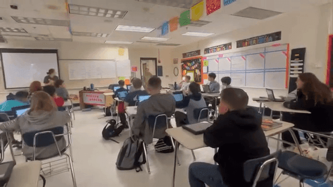 Welsh enters the classroom. Her son, in the black hoodie in the foreground of the photo, soon spots her.{&nbsp;}(IRCSO)